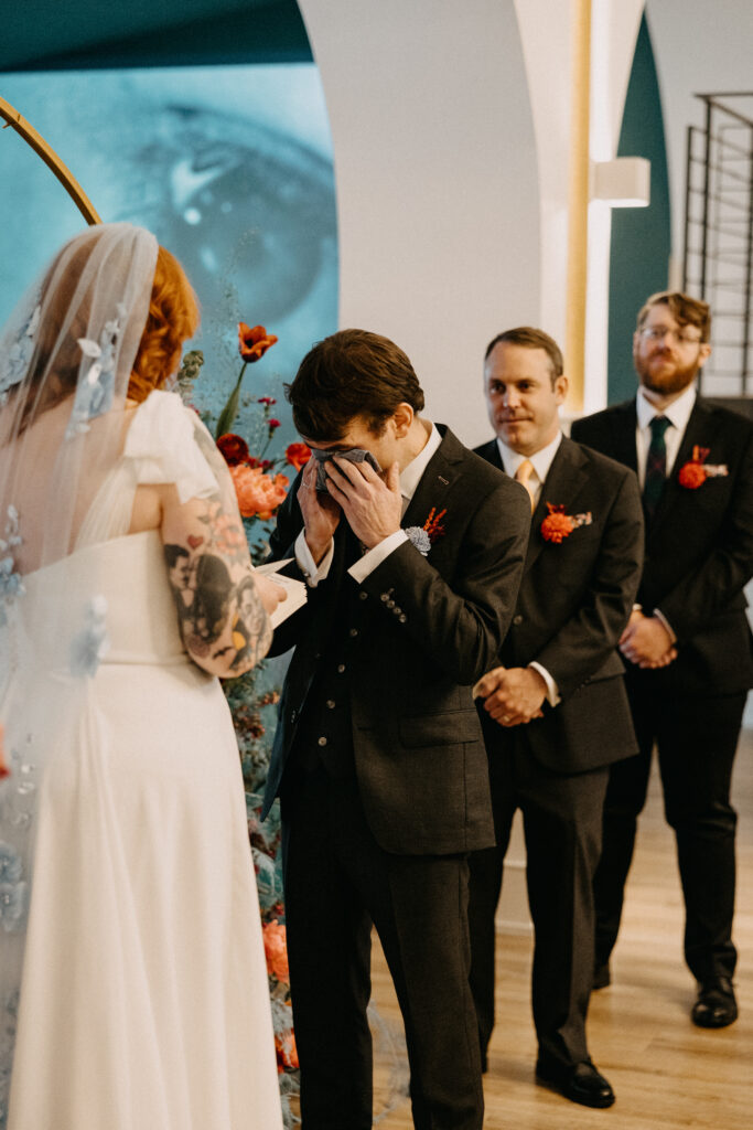 Documentary wedding photography showing the groom crying