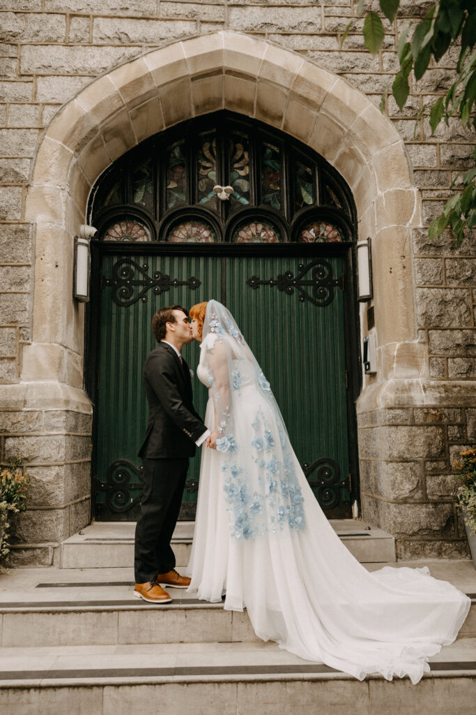 Just married couple kissing outside of the Deacon in Philly